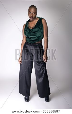 Black African American Female Fashion Model Posing With Trendy Bald Hairstyle And Stylish Clothing I