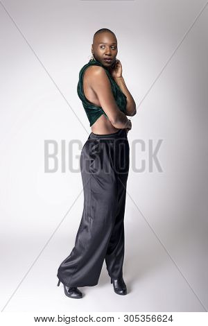 Black African American Female Fashion Model Posing With Trendy Bald Hairstyle And Stylish Clothing I