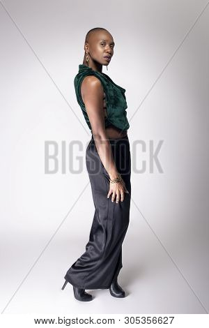 Black African American Female Fashion Model Posing With Trendy Bald Hairstyle And Stylish Clothing I