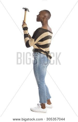 Black African American Female Model Holding A Hammer Repair Tool Looking Independent And Self Relian