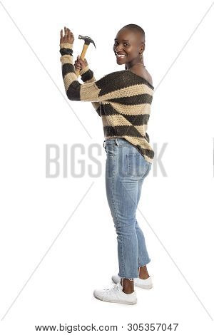 Black African American Female Model Holding A Hammer Repair Tool Looking Independent And Self Relian