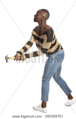 Black African American Female Swinging A Hammer Pretending To Hit Or Smash On A White Background.  S
