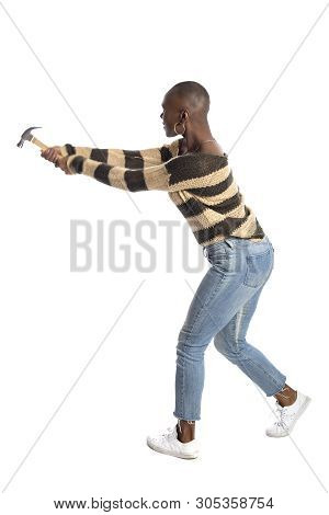 Black African American Female Swinging A Hammer Pretending To Hit Or Smash On A White Background.  S