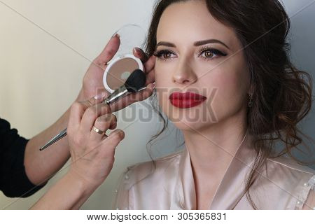 Make-up Artist Working In Make-up Studio, Applies A Make-up Brush To Face. Female Face Close Up.