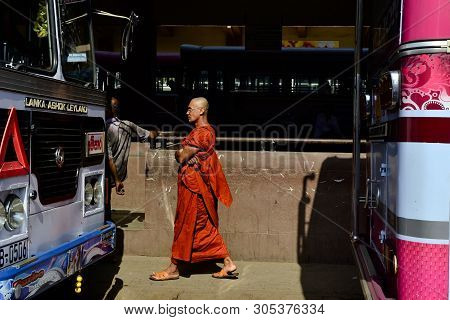 Matara, Sri Lanka: March, 2017: Buddhist Monk In Orange Robes (traditional Buddhism Clothing) On A B