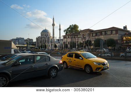 Istanbul, Turkey - September, 2018: Yellow Taxi Car On The Road On A Background Of Mosque.