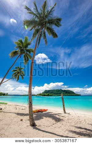 Amazing Port Orly sandy beach with palm trees, Espiritu Santo Island, Vanuatu.