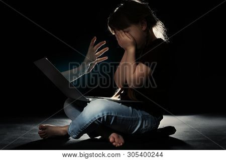 Stranger Reaching Frightened Little Child With Laptop On Dark Background. Cyber Danger