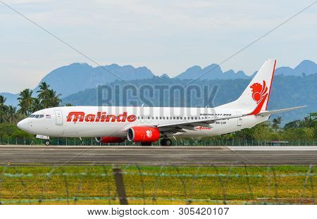 Passenger Airplane Taxiing On Runway Of Airport