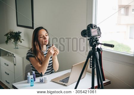 Girl Videoblogger Or Beauty Blogger Records Video For Subscribers. She Shows Lipstick And Tells How 