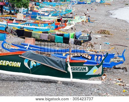 Maasim, The Philippines - May 31, 2019: Traditional Fishing Boats With Outriggers On The Beach In Ma