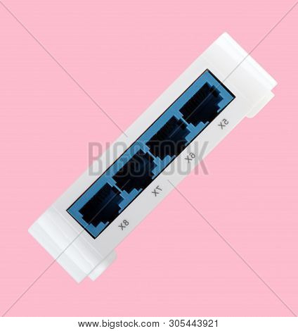 White 8 Port Plastic Ethernet Switch Isolated On Pink Background At Dry Day