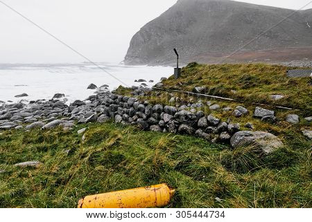 Grass Roof Cabin (stokkvika) At The Coast During Sunset On Lofoten Islands In Norway Near Fredvang.