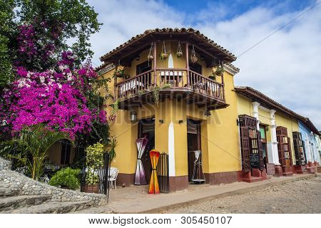 Cuba Trinidad. Corner Of Old Two Floor Building Restaurant With Violet And Purple Flowers. Beautiful