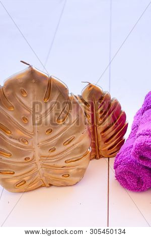 Monstera Golden Leaf With Towels Life Style, Natural Background On White Wooden Planks