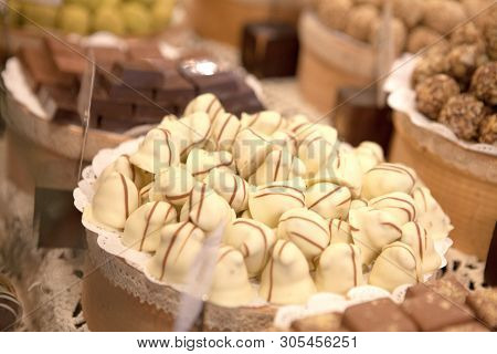 Asorted Chocolate Truffles And Pralines. Chocolate And Coconut Candies On The Counter In The Confect