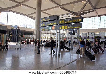 Malaga, Spain - March 16 2010 - Passengers Waiting To Check In For Flights In Terminal Three Departu