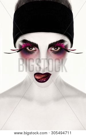 Young Creative Woman With Surrealistic Face Art Showing Tongue