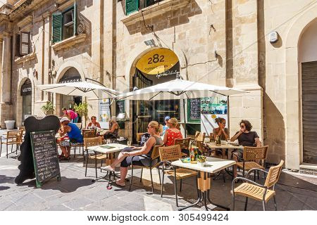 Valetta, Malta - September 13th 2015: Tourists Sat Outside A Cafe In A Square. The City Is A Popular