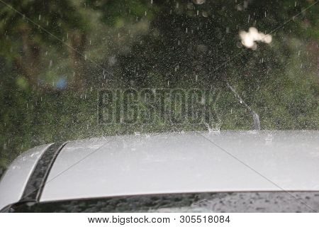 Hard Rain Is Falling On A Roof Of A Car