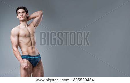 Young Male Athlete Bodybuilder Posing. Handsome Athletic Male Power Guy. Fitness Muscular Person. Yo