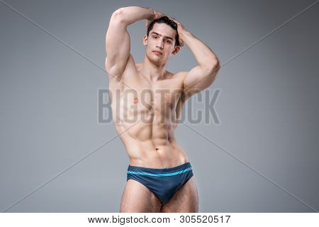 Young Male Athlete Bodybuilder Posing. Handsome Athletic Male Power Guy. Fitness Muscular Person. Yo