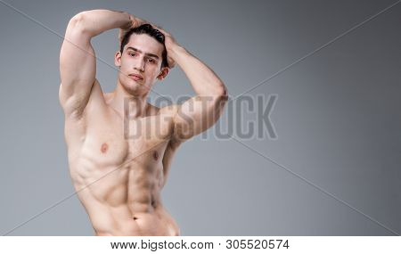 Young Male Athlete Bodybuilder Posing. Handsome Athletic Male Power Guy. Fitness Muscular Person. Yo