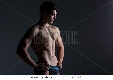 Young Male Athlete Bodybuilder Posing. Handsome Athletic Male Power Guy. Fitness Muscular Person. Yo