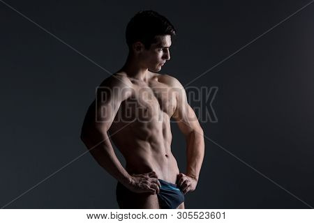 Young Male Athlete Bodybuilder Posing. Handsome Athletic Male Power Guy. Fitness Muscular Person. Yo