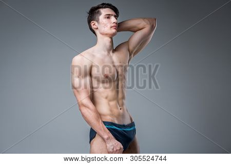 Studio Portrait Young Caucasian Man On Gray Background Posing. Theme Of Puberty, Problem Skin, Teen 