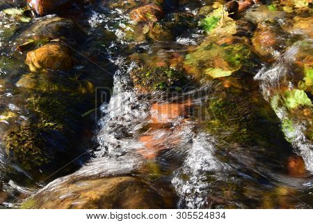 View Of Evening Fast Mountain Stream Near Karst Blue Lake With Trees And Trees In Cherek Gorge In Mo
