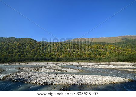 View Of A Mountain River With Stones And Mountains In The Cherek Gorge In The Mountains Of The North
