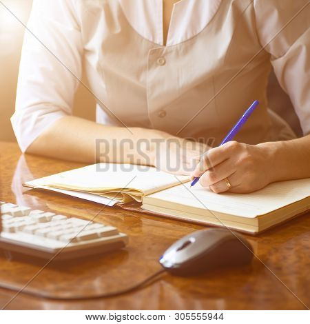 Doctor Woman Writes In The Diary Of Current Affairs In The Dental Clinic