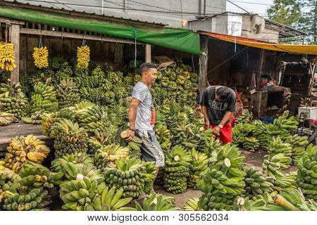 Makassar, Sulawesi, Indonesia - February 28, 2019: Terong Street Market. Two Banana Vendors Offer Ma