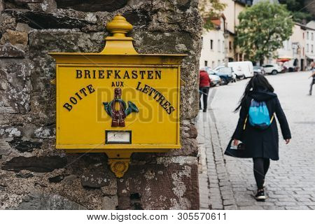 Vianden, Luxembourg - May 18, 2019: Yellow Post Box On A Wall In Vianden, Town In Luxembourgs Ardenn