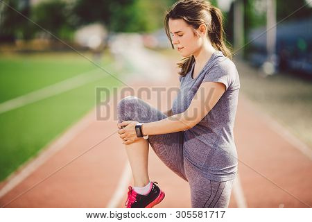 Beautiful Young Caucasian Woman With Long Hair In Tail And Big Breasts Doing Exercises, Warming Up A