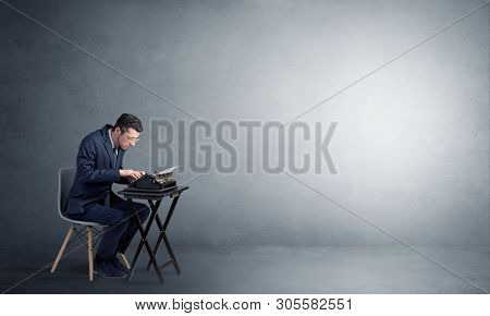 Man working hard on a typewriter in an empty space