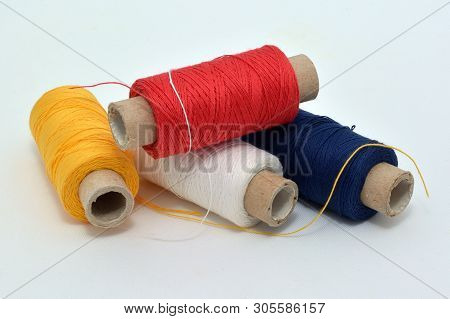 Sewing Colored Threads: Yellow, Red, Dark Blue, White.