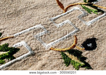 Linen Fabric Texture . Embroidered Flowers . Beautiful Cloth From Natural Fabric