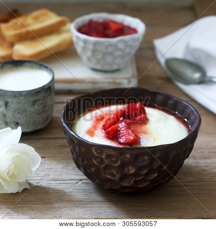 Homemade Breakfast Of Semolina Porridge, Strawberry Sauce, Coffee With Milk And Toast On A Wooden Ba