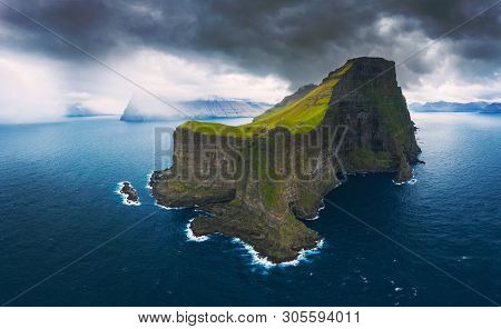 Aerial Panorama Of A Small White Lighthouse Located On The Edge Of A Huge Cliff And The Island Of Ka