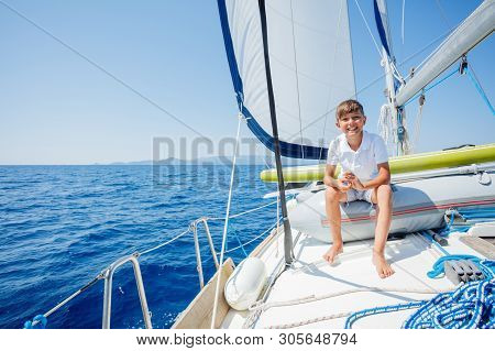 Little Boy On Board Of Sailing Yacht On Summer Cruise. Travel Adventure, Yachting With Child On Fami