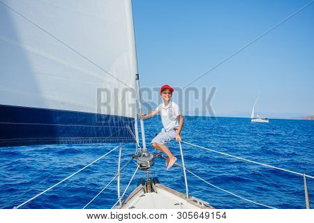 Little Boy On Board Of Sailing Yacht On Summer Cruise. Travel Adventure, Yachting With Child On Fami