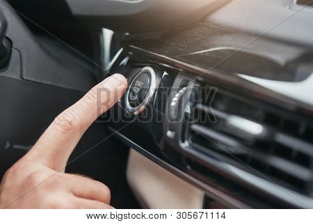 Engine Starting. Cropped Image Of A Hand Pushing On The Start And Stop Button Of Car Motor.