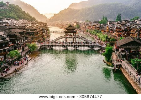 2 June 2019, Fenghuang China : Tuo Juang River Scenery With Antique Bridge And Dramatic Light In Fen