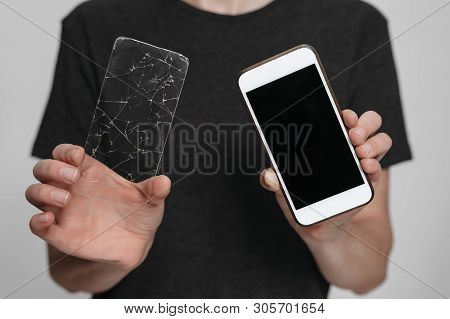 Worker Of Service Center Holding In Hands Smartphone And Broken Screen Protection. Phone Save Concep