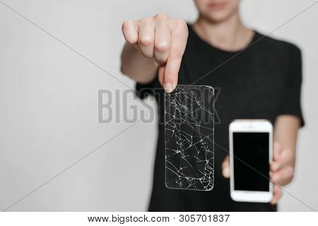 Close Up, Hands Holding Broken Screen Protection And Saved Smartphone. Phone Save Concept. Isolated 