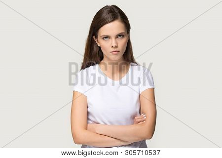 Dissatisfied Millennial Woman Looking At Camera Posing On Grey Background