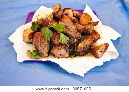 Chopped  Bbq Pieces Of  Mutton, Beef Or Chicken Meat On The Plate With Greenery Of Parsley And Dill