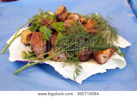 Chopped  Bbq Pieces Of  Mutton, Beef Or Chicken Meat On The Plate With Greenery Of Parsley And Dill